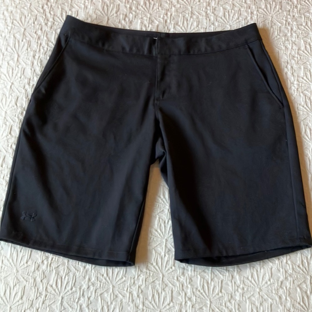 Black Under Armour polyester  performance shorts with slide pockets.